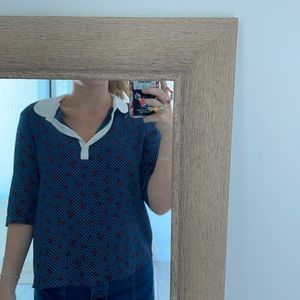 Polka dot blouse with red details and white neck